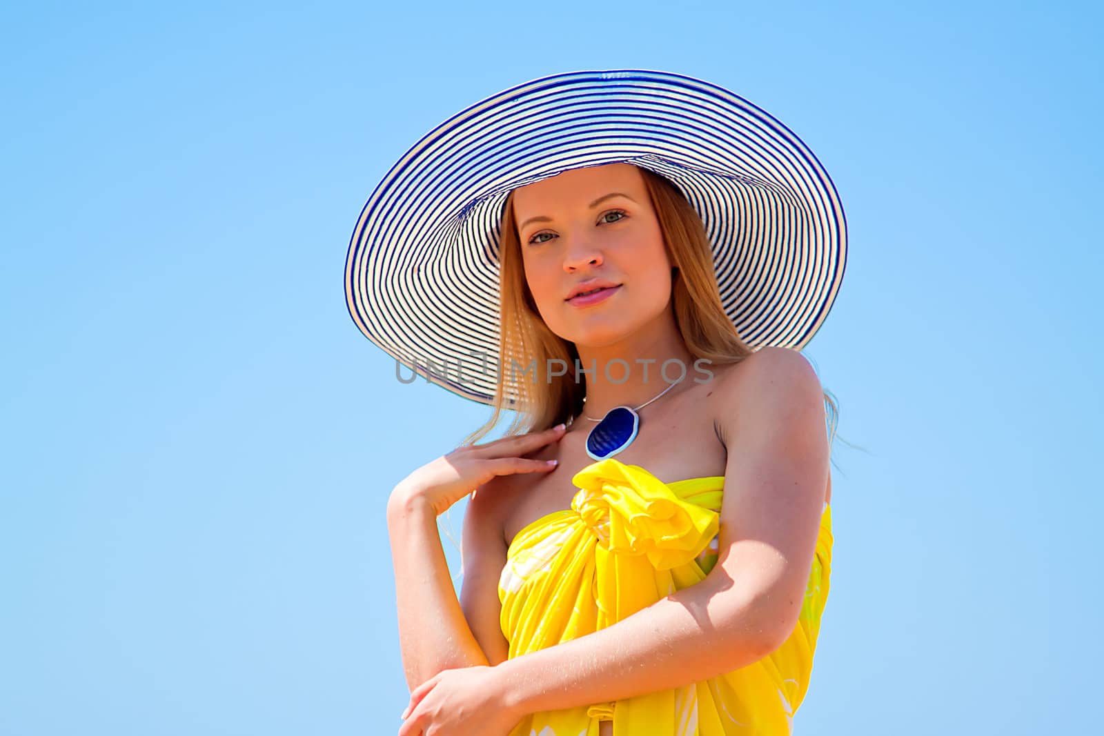 Photo of a young and beautiful woman resting on the sea coast