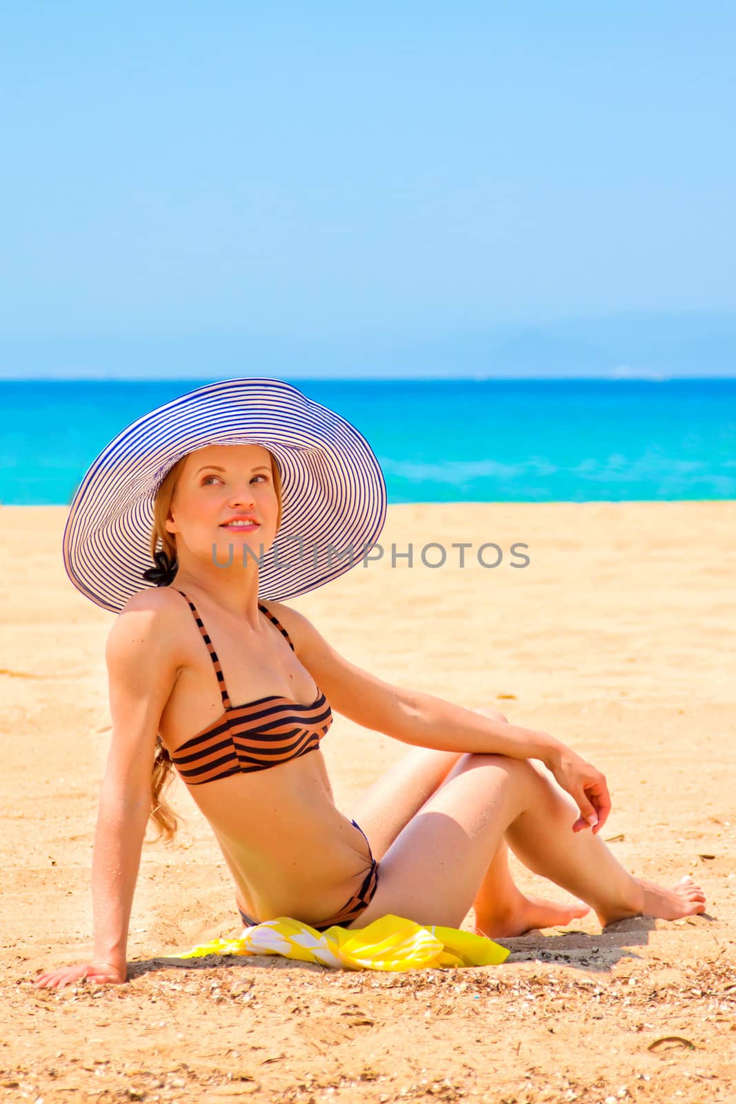 Woman relaxing on the beach by korvin79
