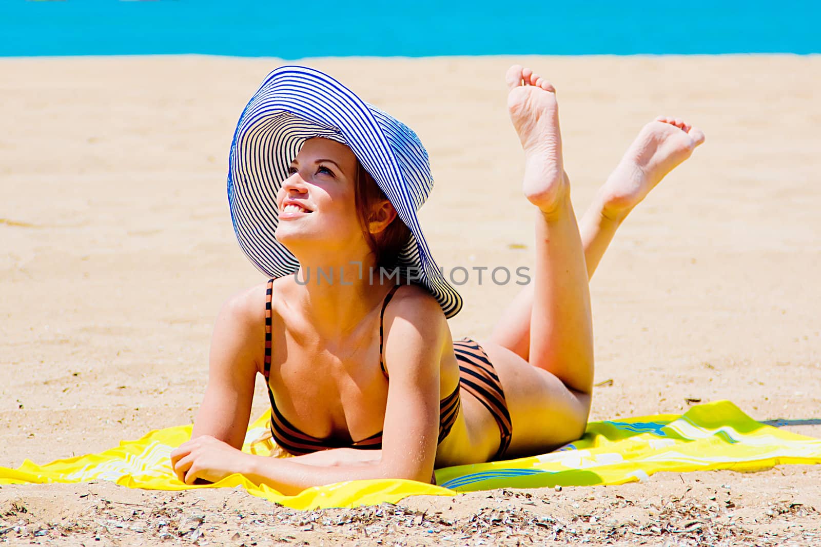 Photo of a young and beautiful woman resting on the sea coast