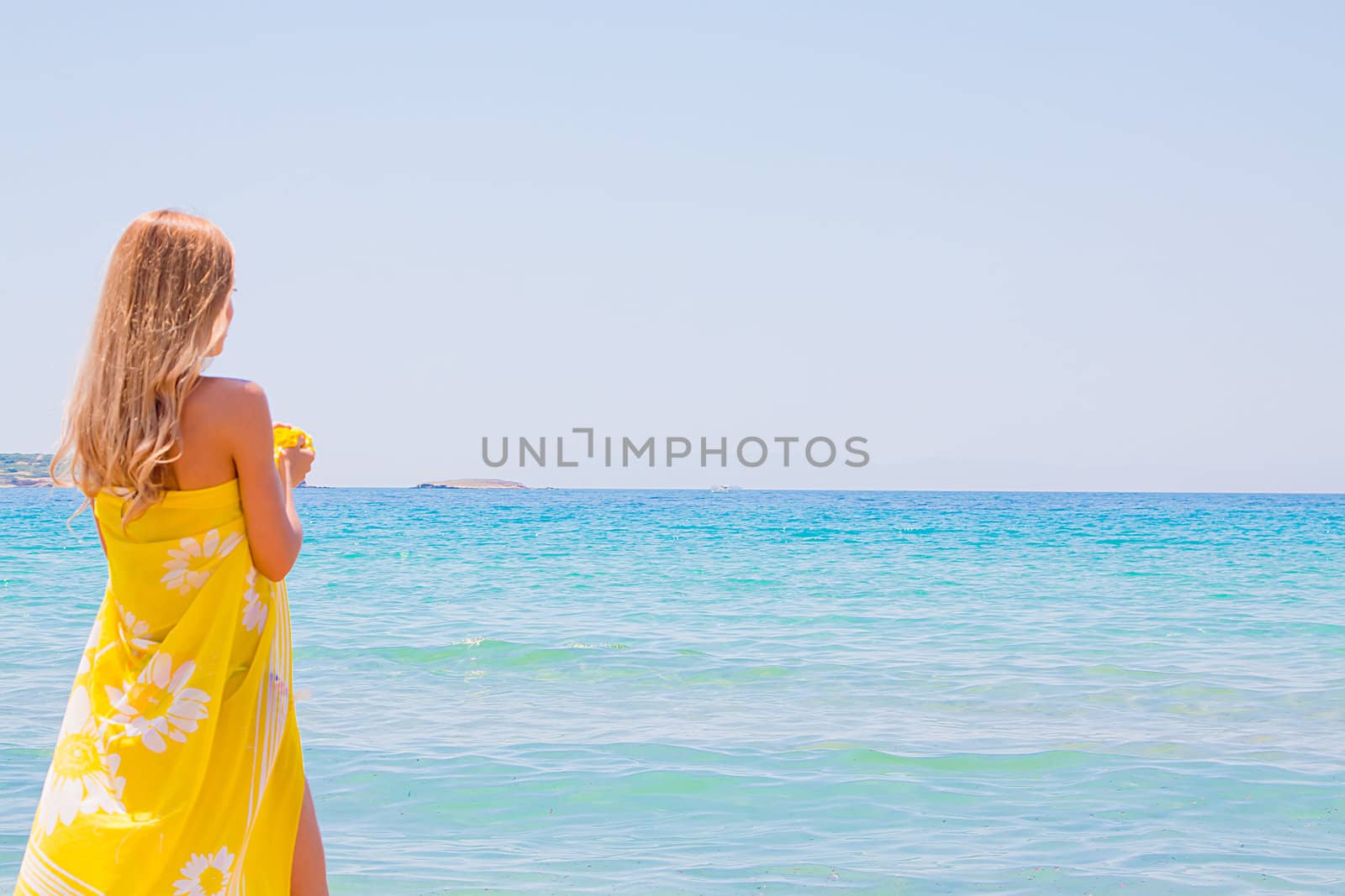 Photo of a young and beautiful woman resting on the sea coast