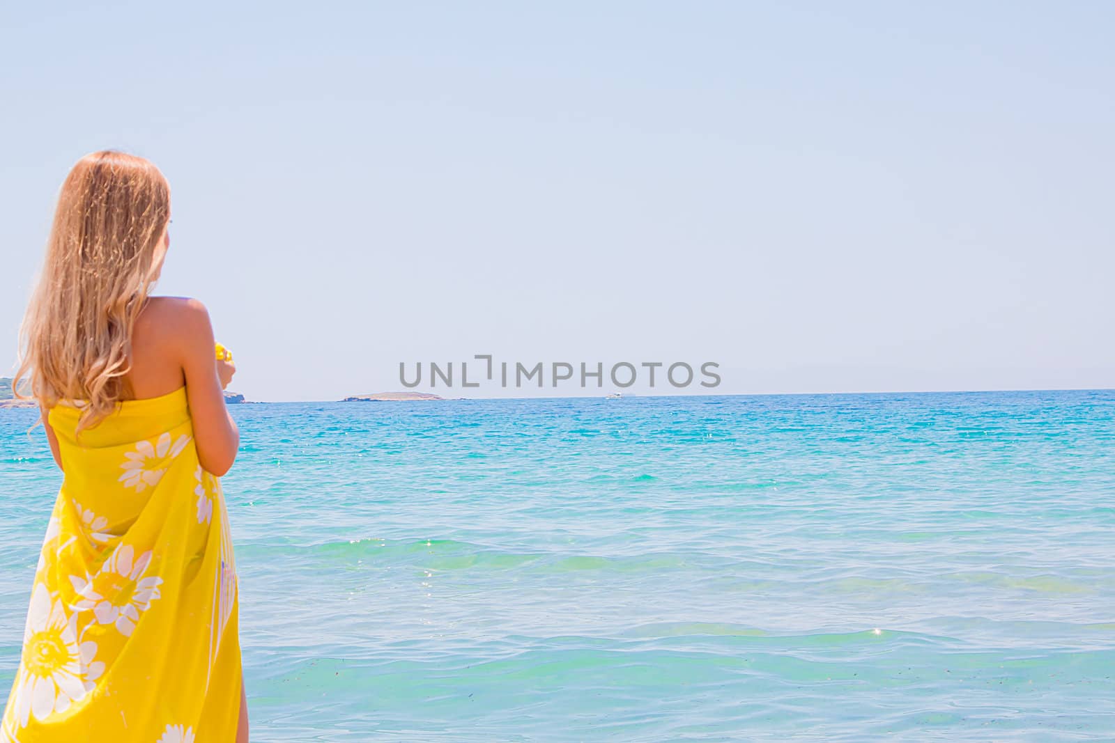 Photo of a young and beautiful woman resting on the sea coast