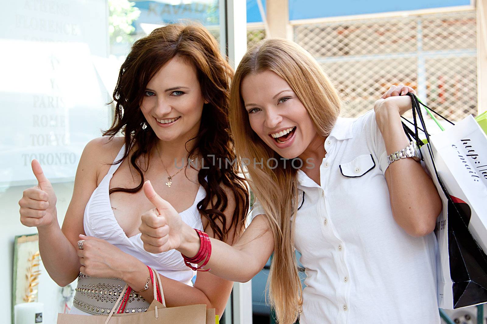 Photo of two young and beautiful women who go shopping