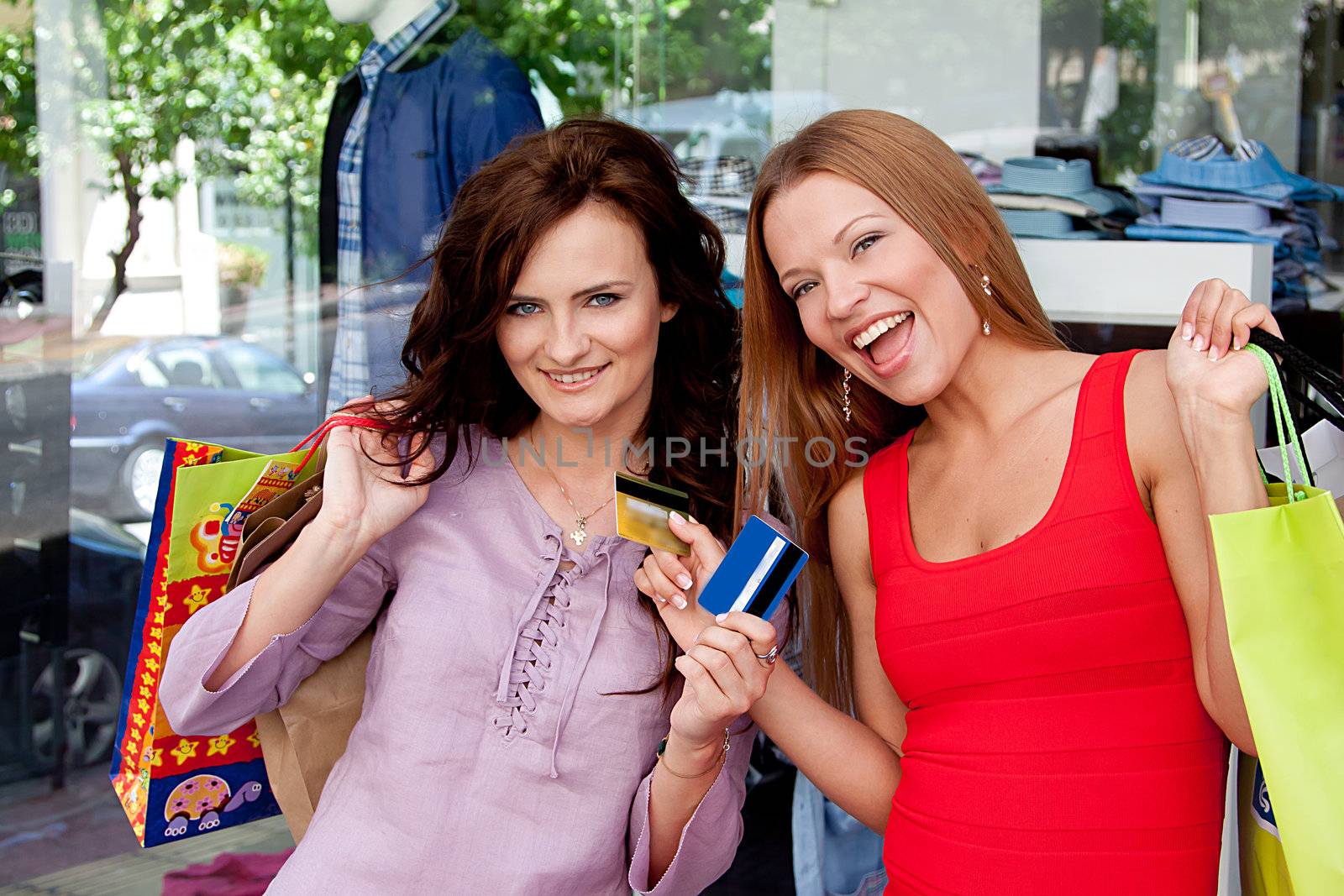 Photo of two young and beautiful women who go shopping