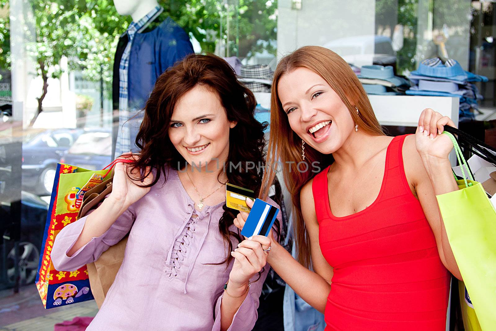 Photo of two young and beautiful women who go shopping