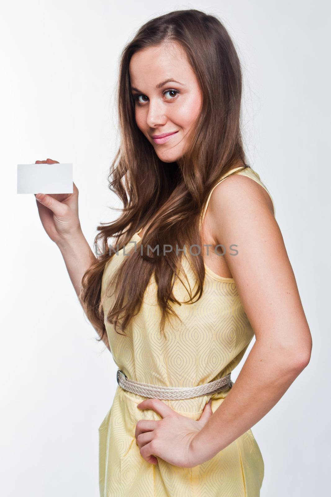 Photo of a young and beautiful woman with a business card in the hands of