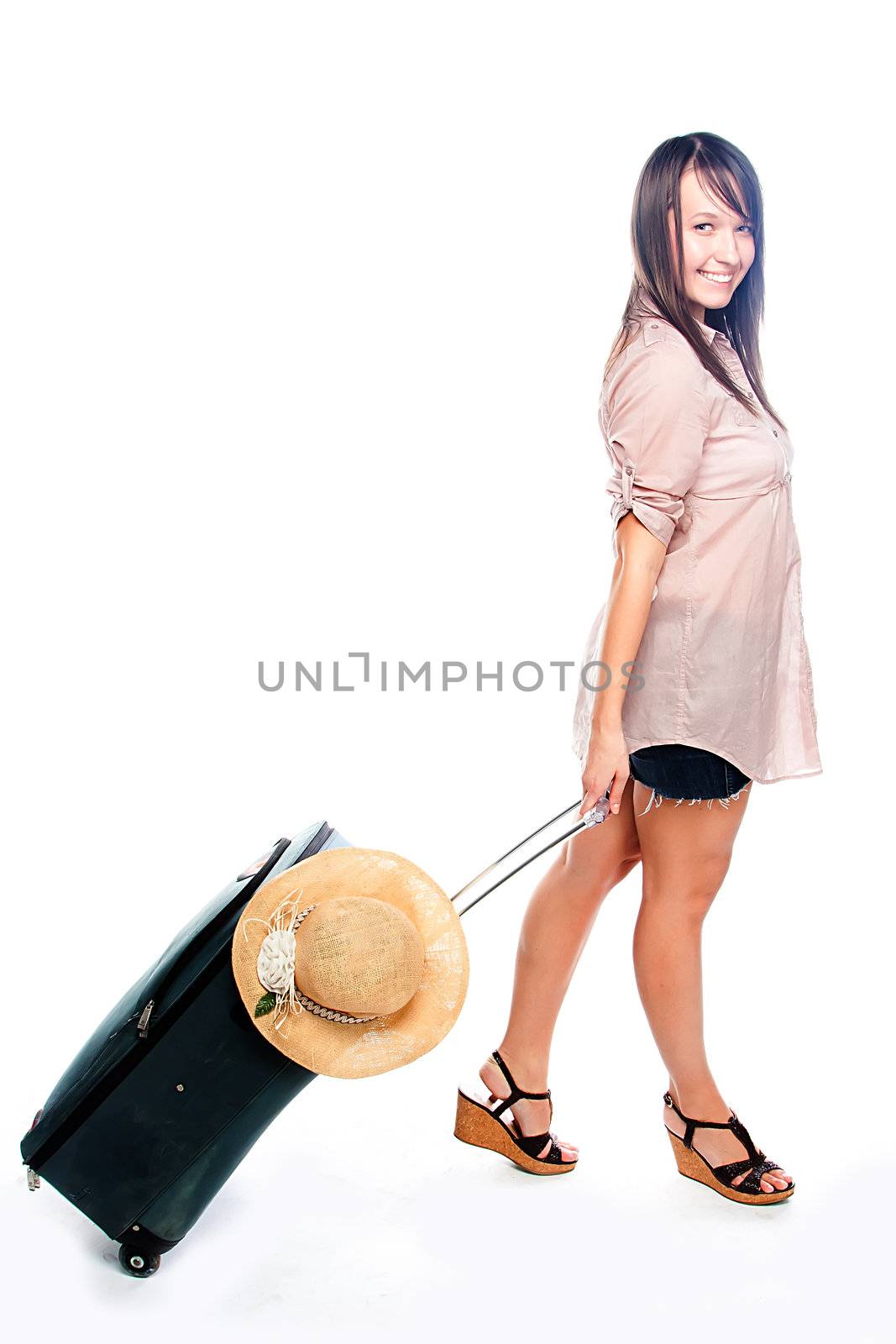 Photo of a young and beautiful girl with a suitcase, passport and ticket isolated on white background