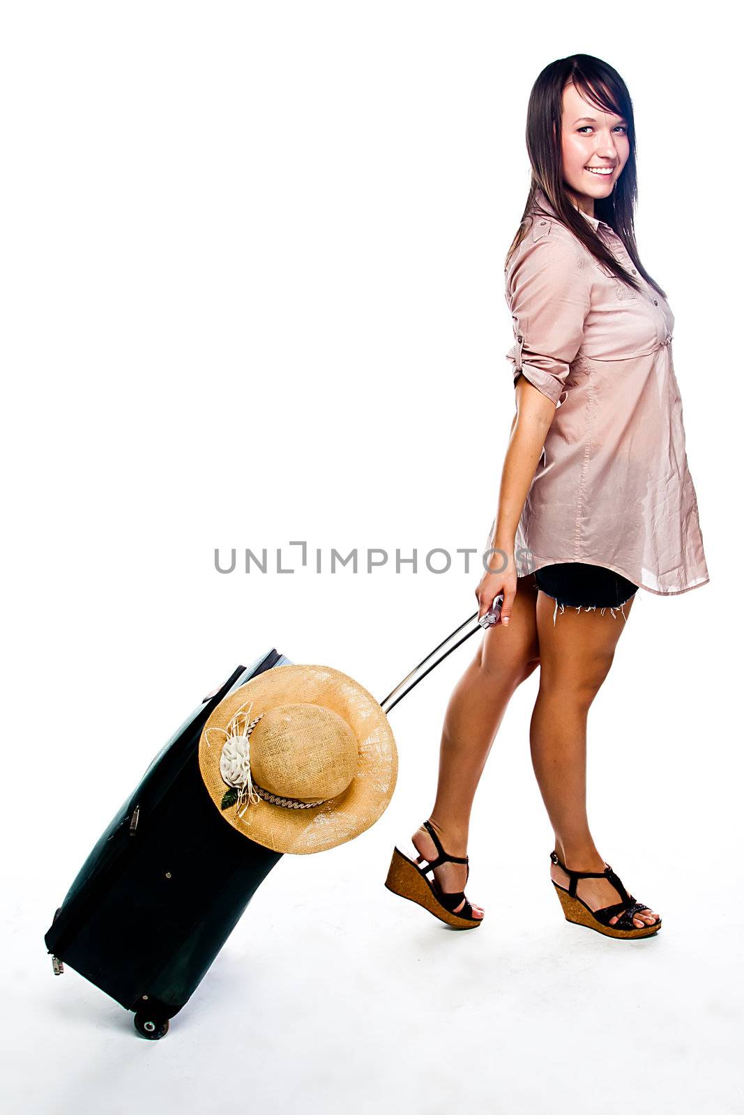 Photo of a young and beautiful girl with a suitcase, passport and ticket isolated on white background