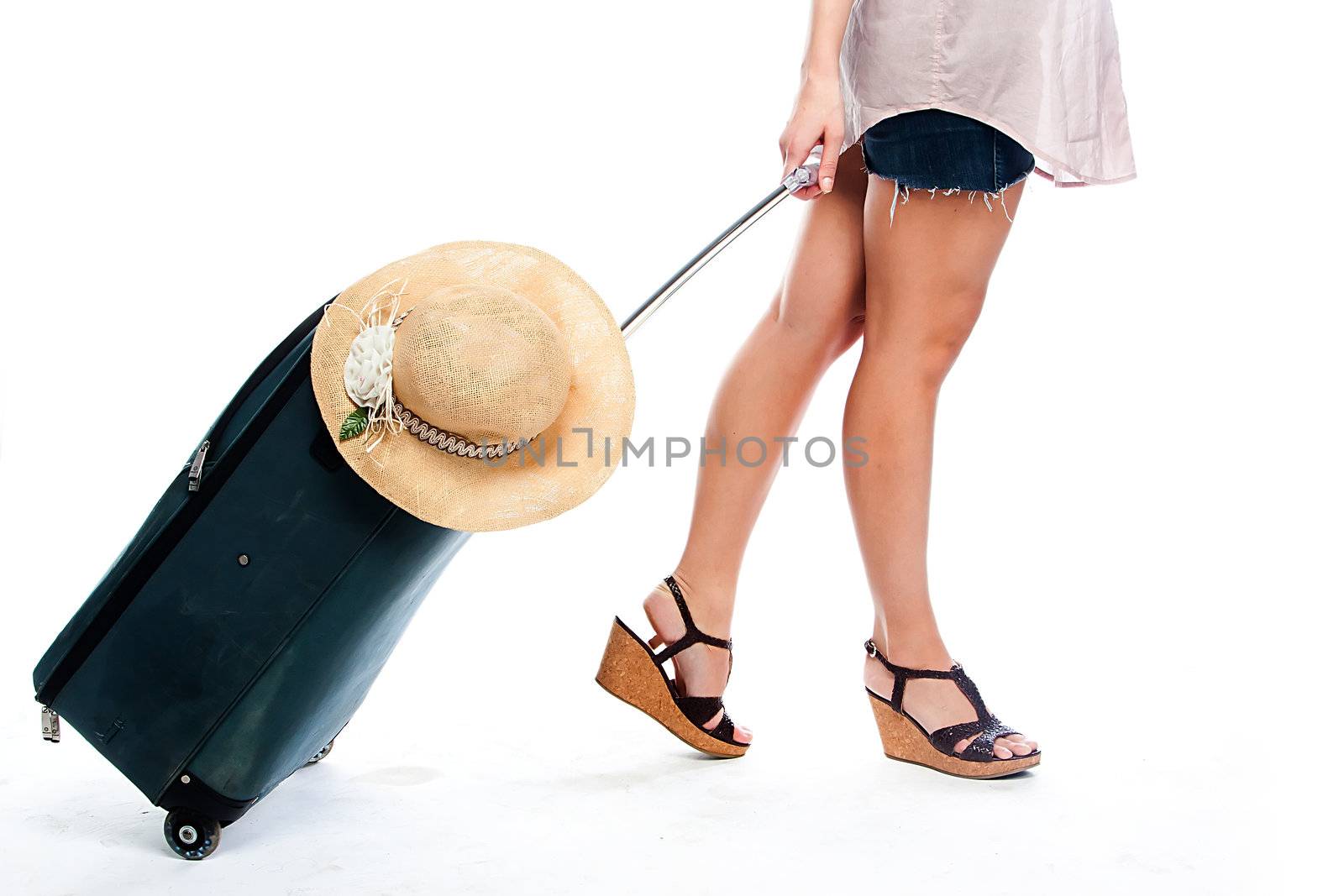 Photo of a young and beautiful girl with a suitcase, passport and ticket isolated on white background