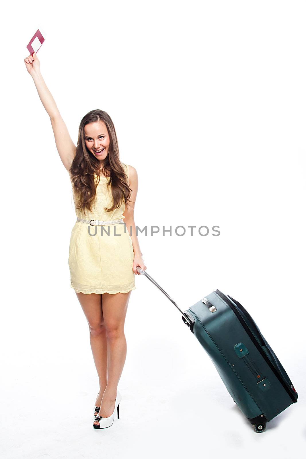 Photo of a young and beautiful girl with a suitcase, passport and ticket isolated on white background
