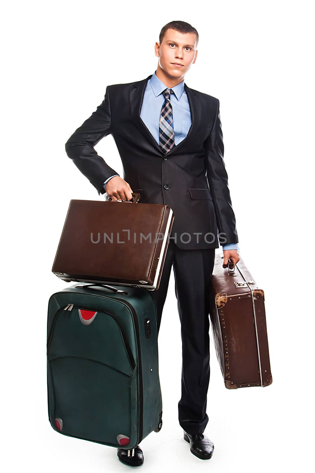 Young successful businessman in a business suit with three suitcases and a journey