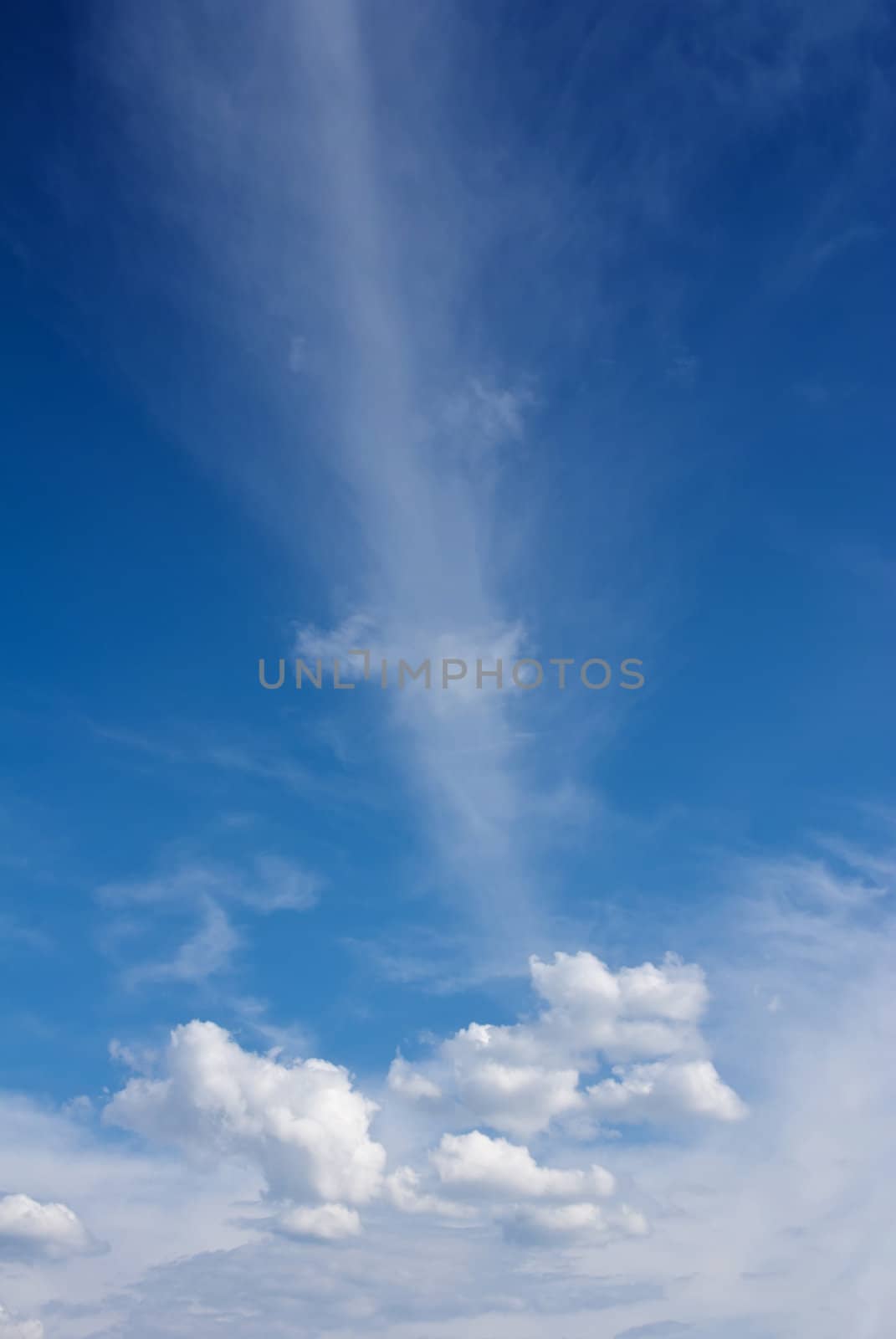 White fluffy clouds against a blue day sky