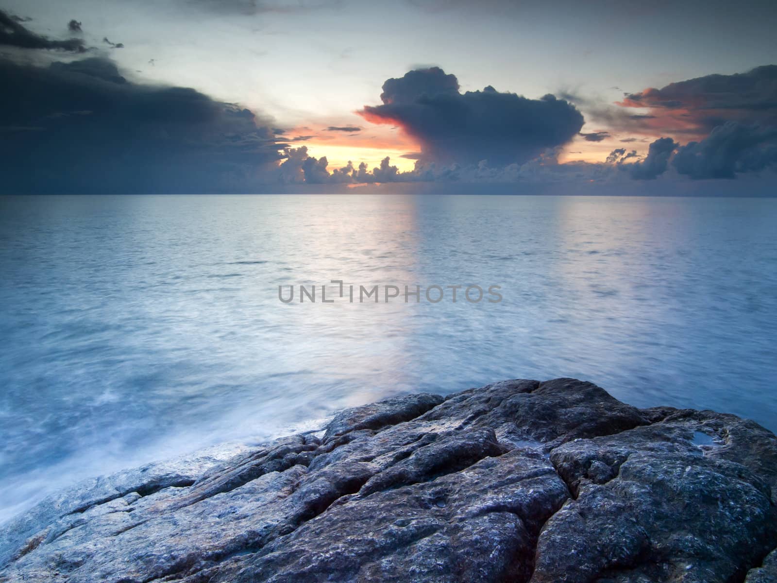 Beautiful seascape. Sea and rock at the sunset