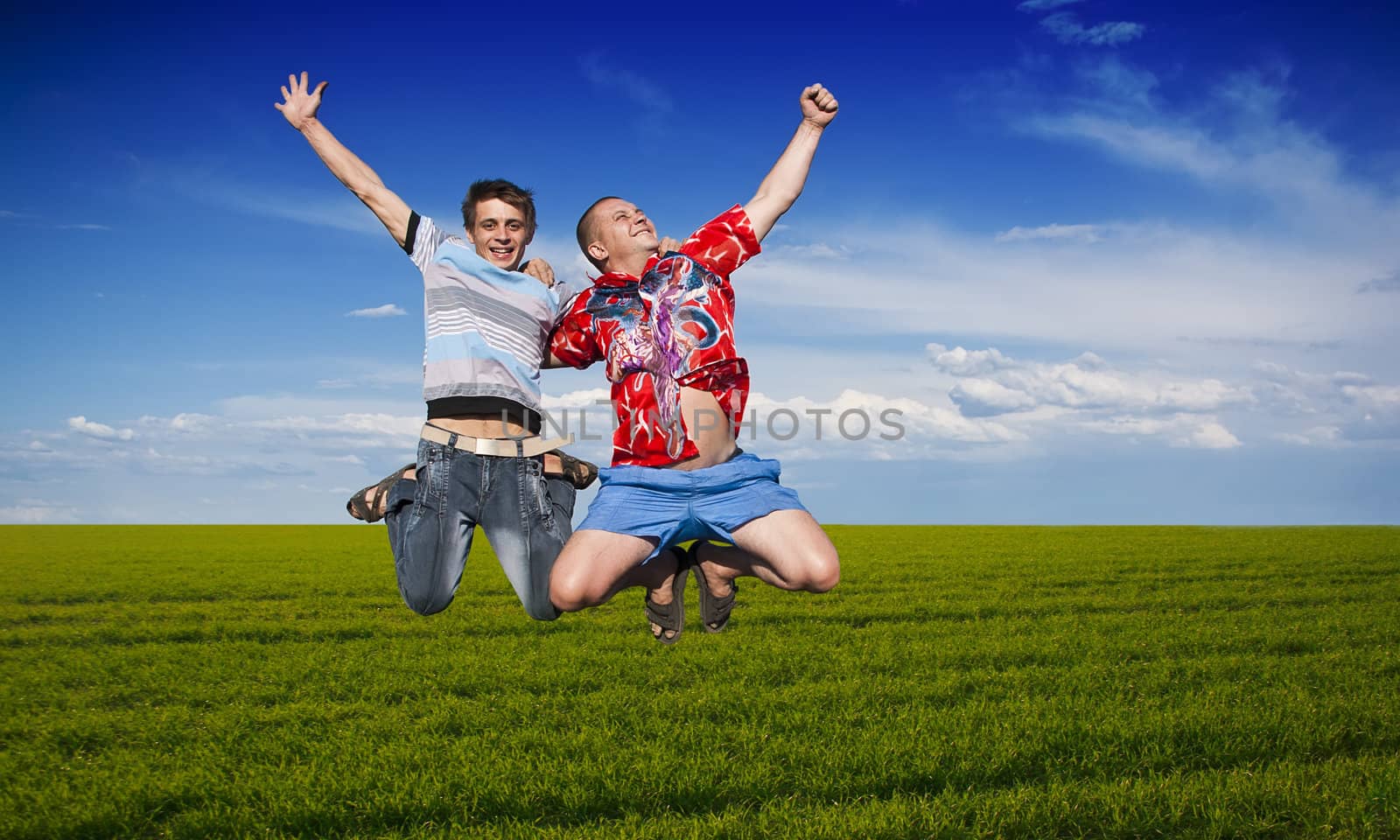 Boys jumping against a background of beautiful sky
