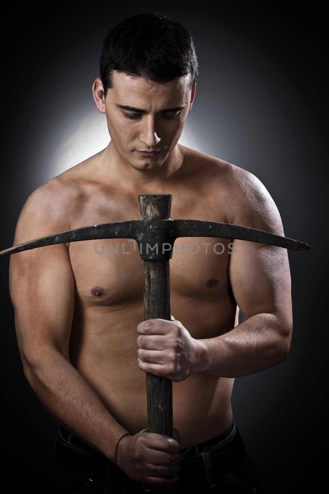 Farmer with pick axe over black background