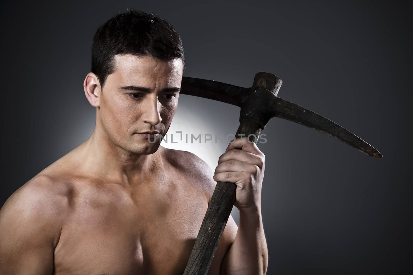 Farmer with pick axe over black background