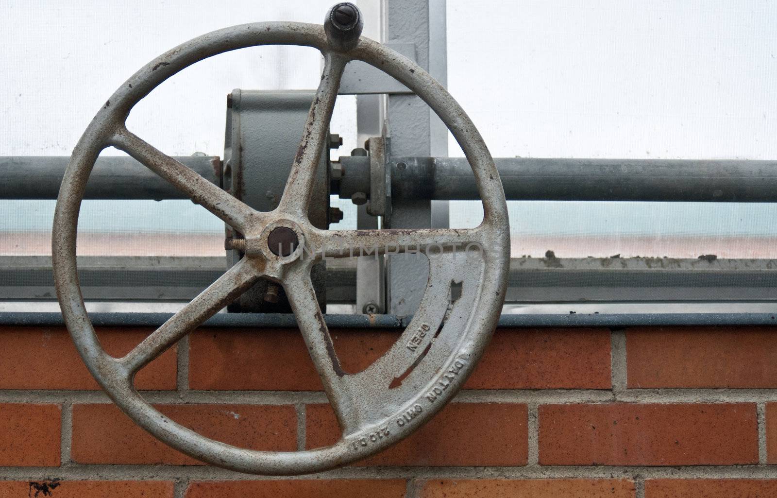 Iron wheel contraption used to open windows at the Botanical Gardens in Ann Arbor, Michigan