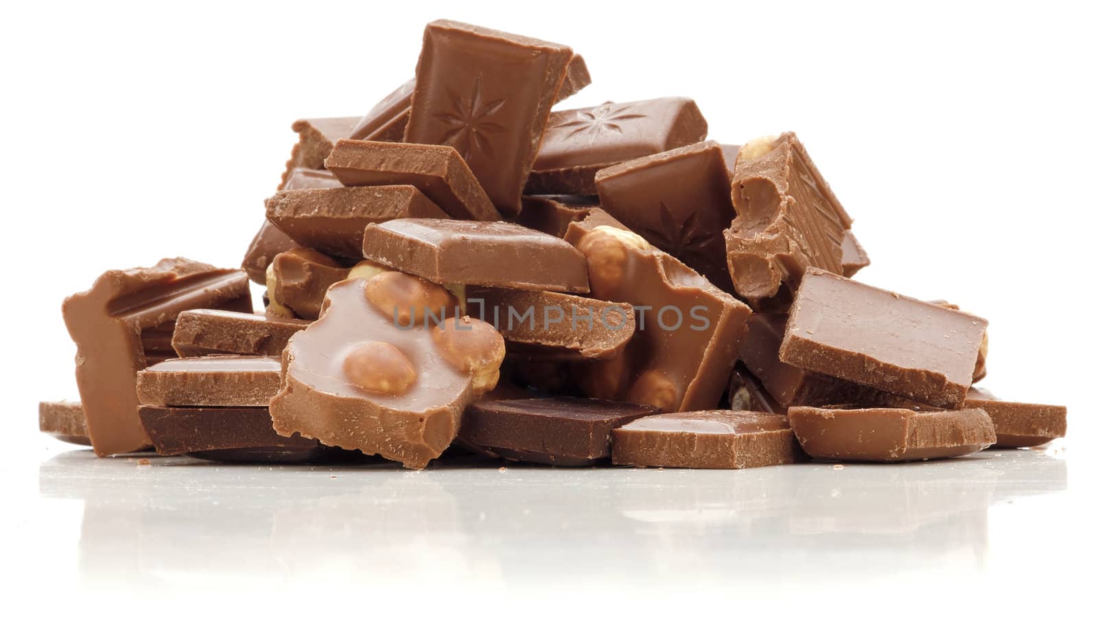 Stack of dark and milk chocolate with nuts isolated on white background.