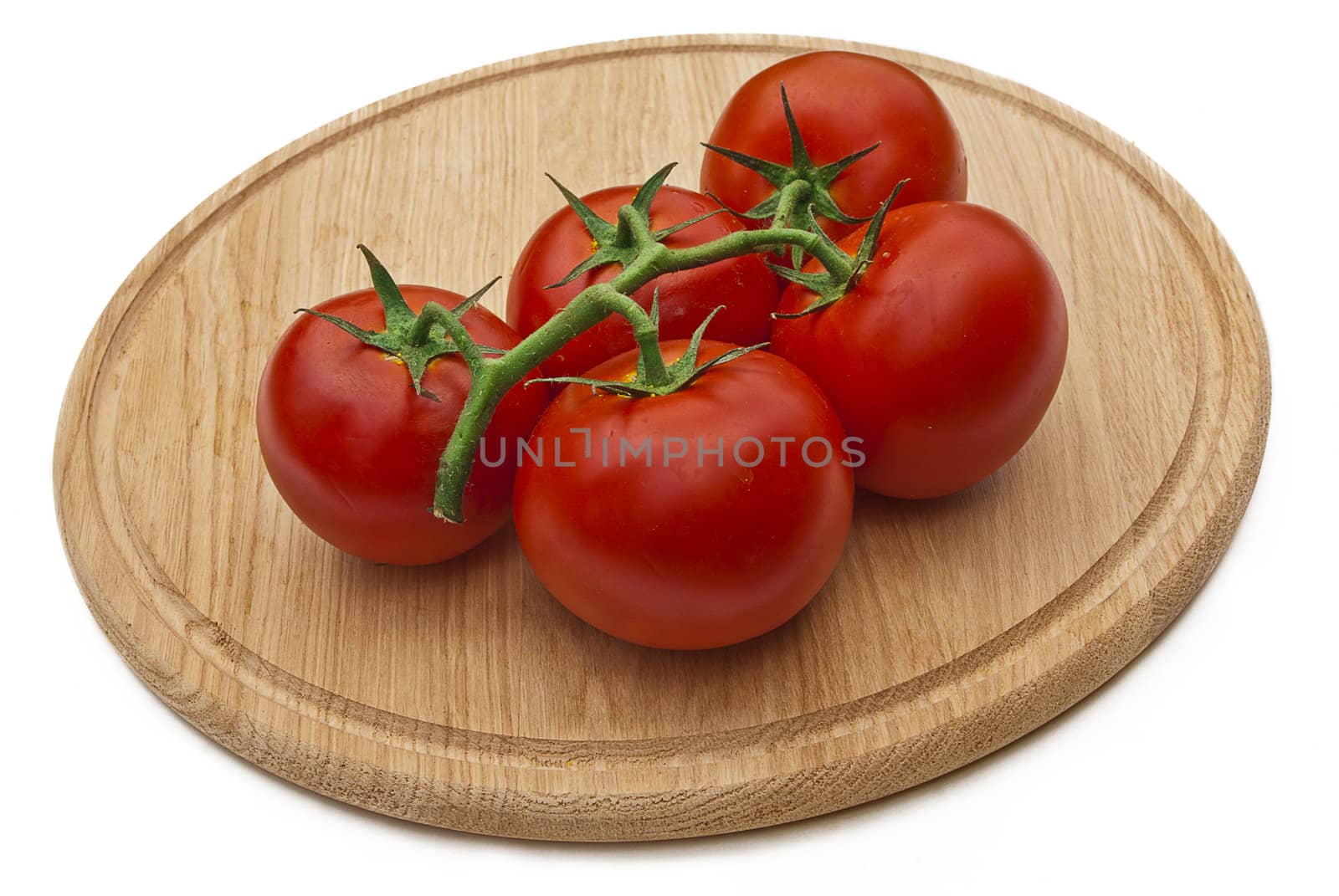 Tomatos on wood cutting board isolated over white