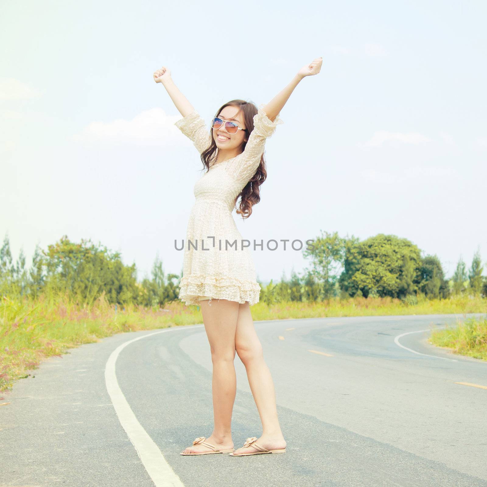 Young asianwoman stan on the road in a happy feel. by jakgree