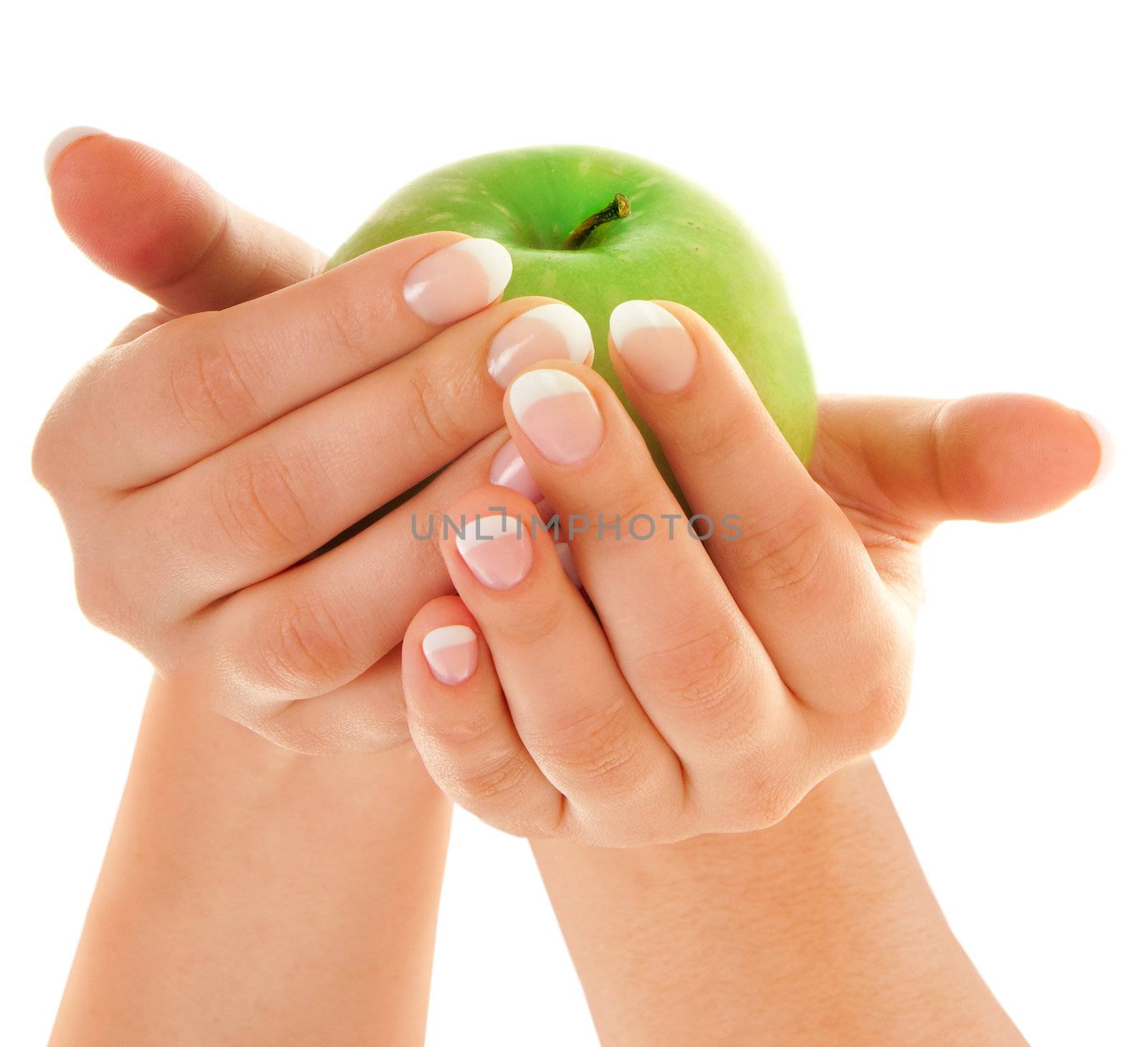 Green fresh apple in beutiful female hands with nice french manicure isolated on white background