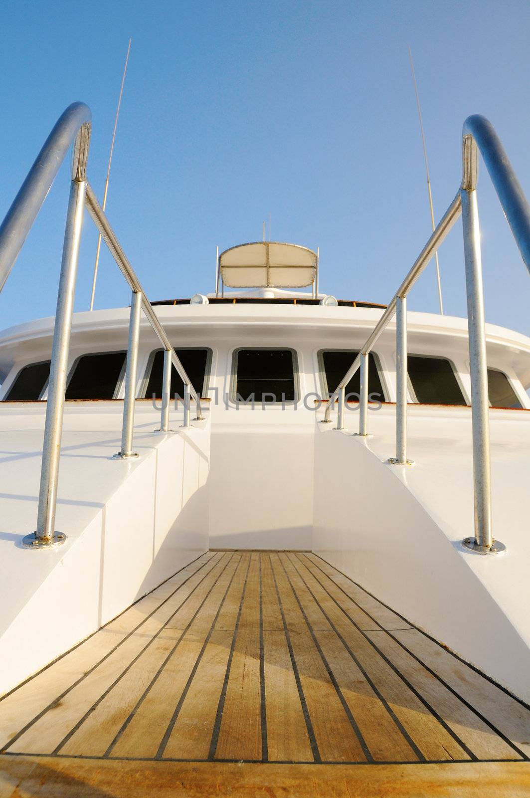 Deck of big wooden marine yacht with ladder and deck cabin