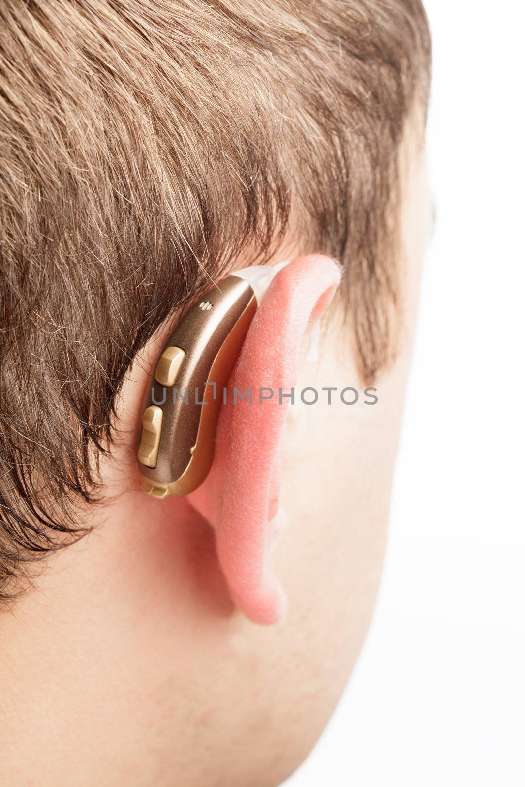 Hearing aid on the man's ear closeup
