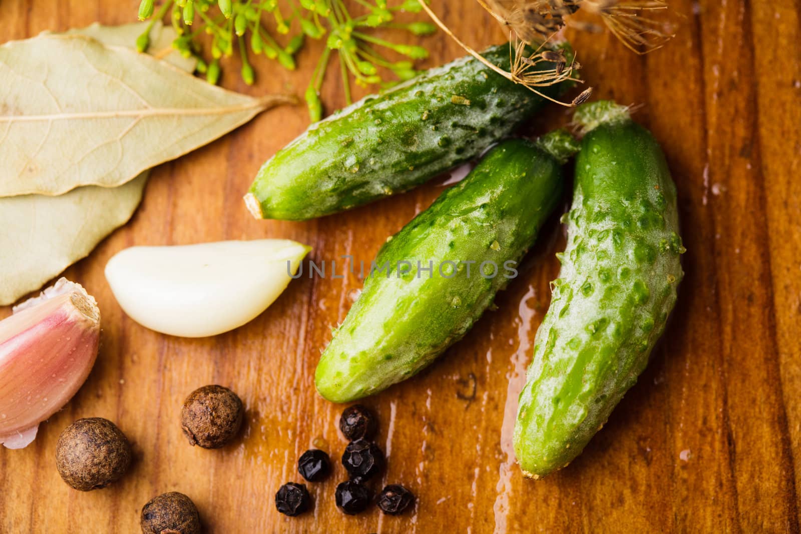 Preparation of small cucumber preserving on wooden table