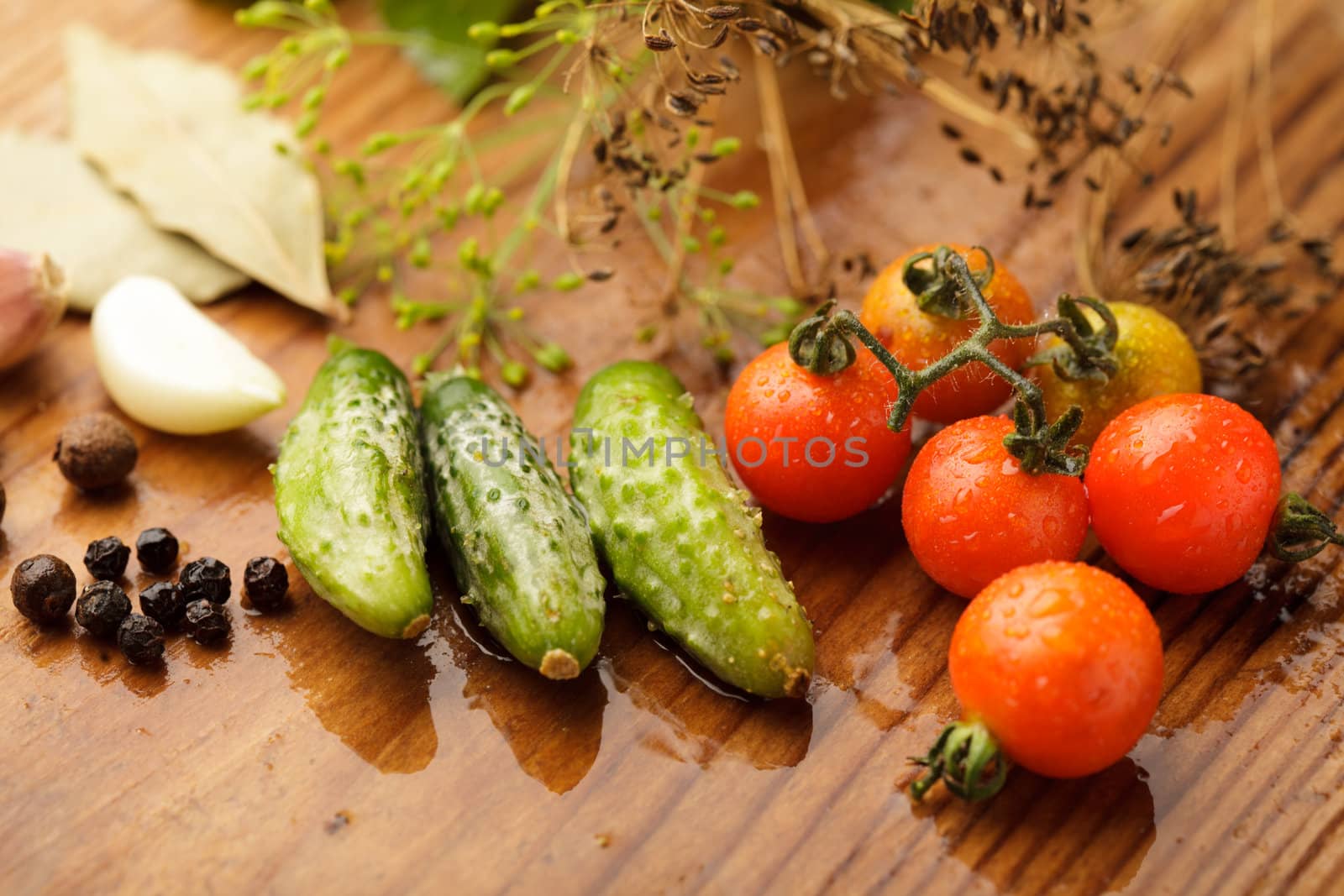 Still life of tomatoes and cucumbers on wooden table in kitchen