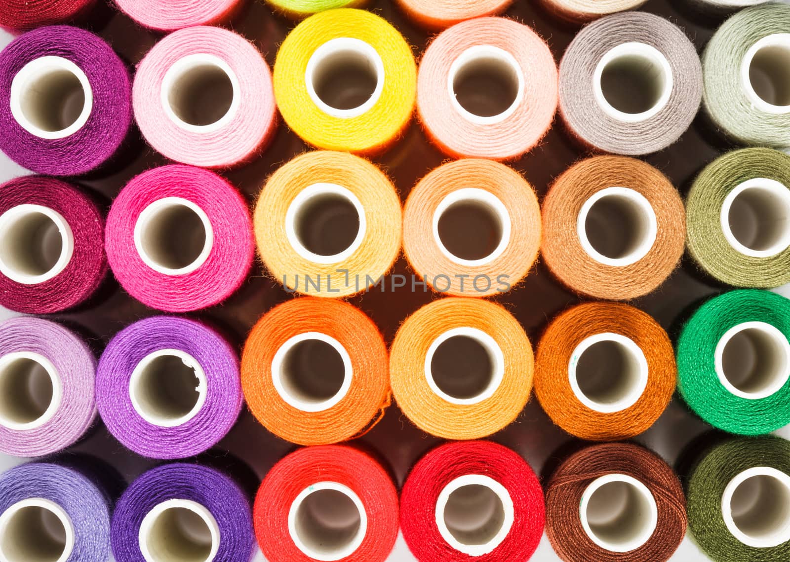 Sewing threads multicolored as a background close up