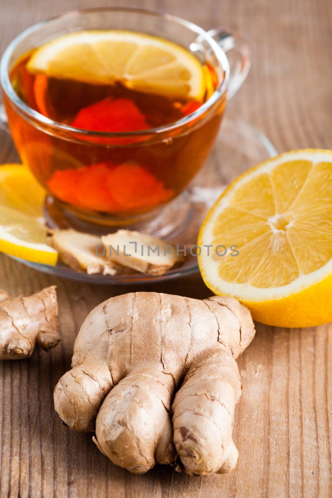 Tea cup with lemon and ginger on the wooden table.