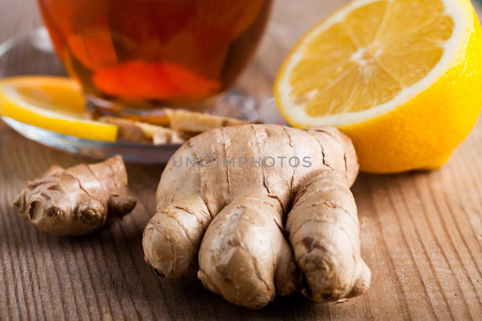 Tea cup with lemon and ginger on the wooden table.