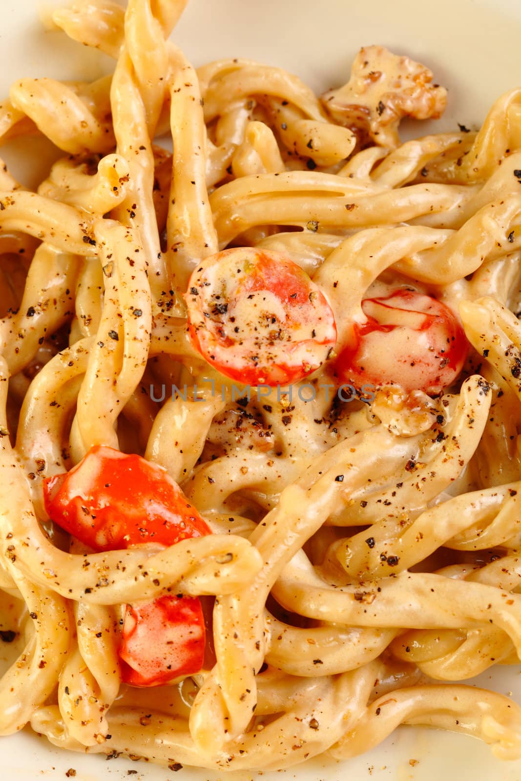 Italian hand made pasta with cream tomatoes and pepper