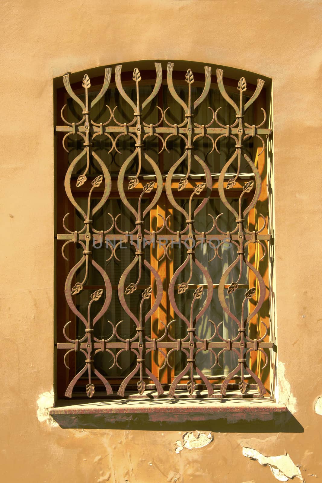 Ancient architecture house window with steel bar by sauletas