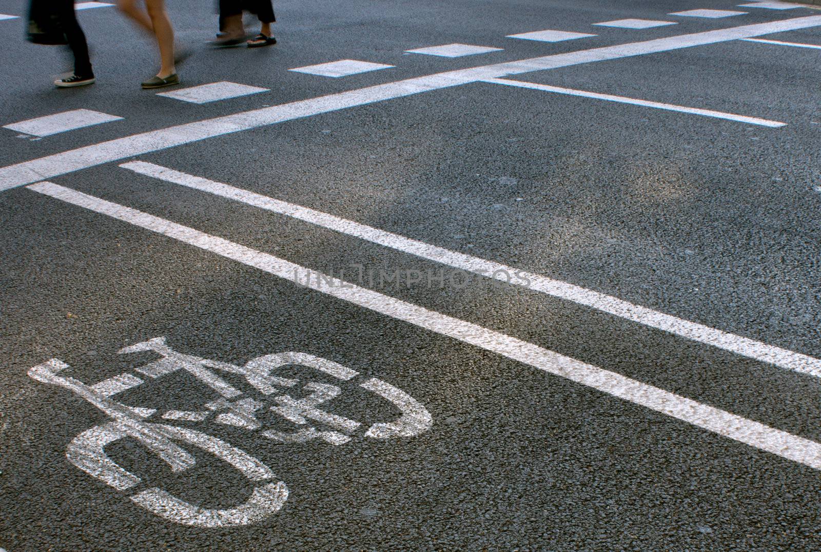 Bicycles and pedestrians lanes painted on the asphalt of a street