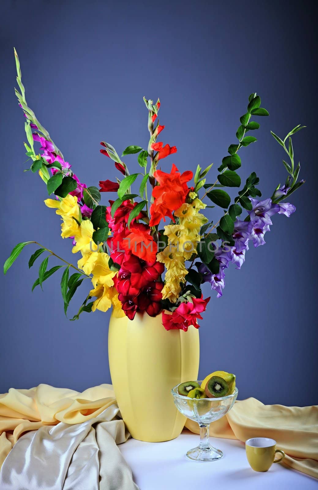 Still life with colorful  gladioluses and fresh fruits