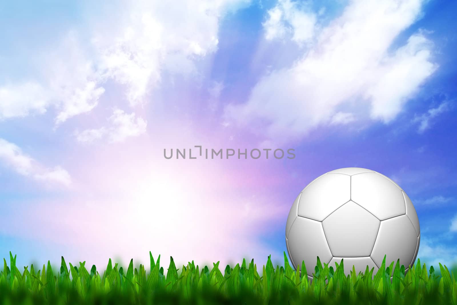 football in green grass over a twilight sky