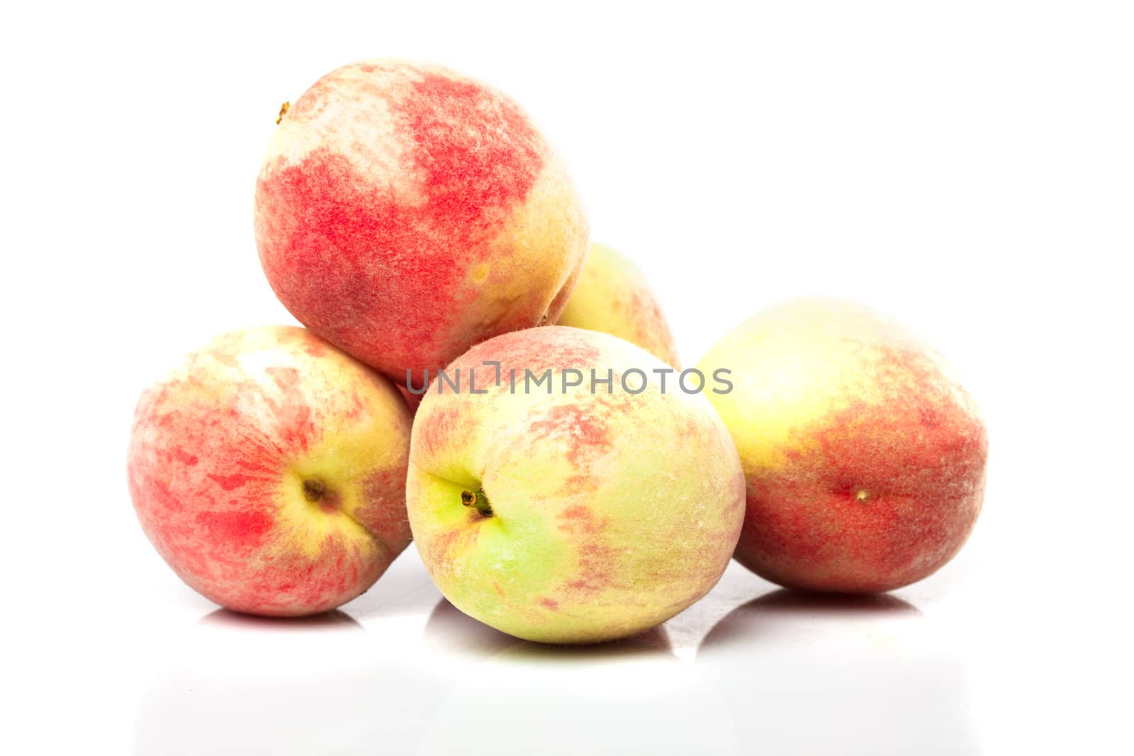 Group of ripe peaches isolated on white