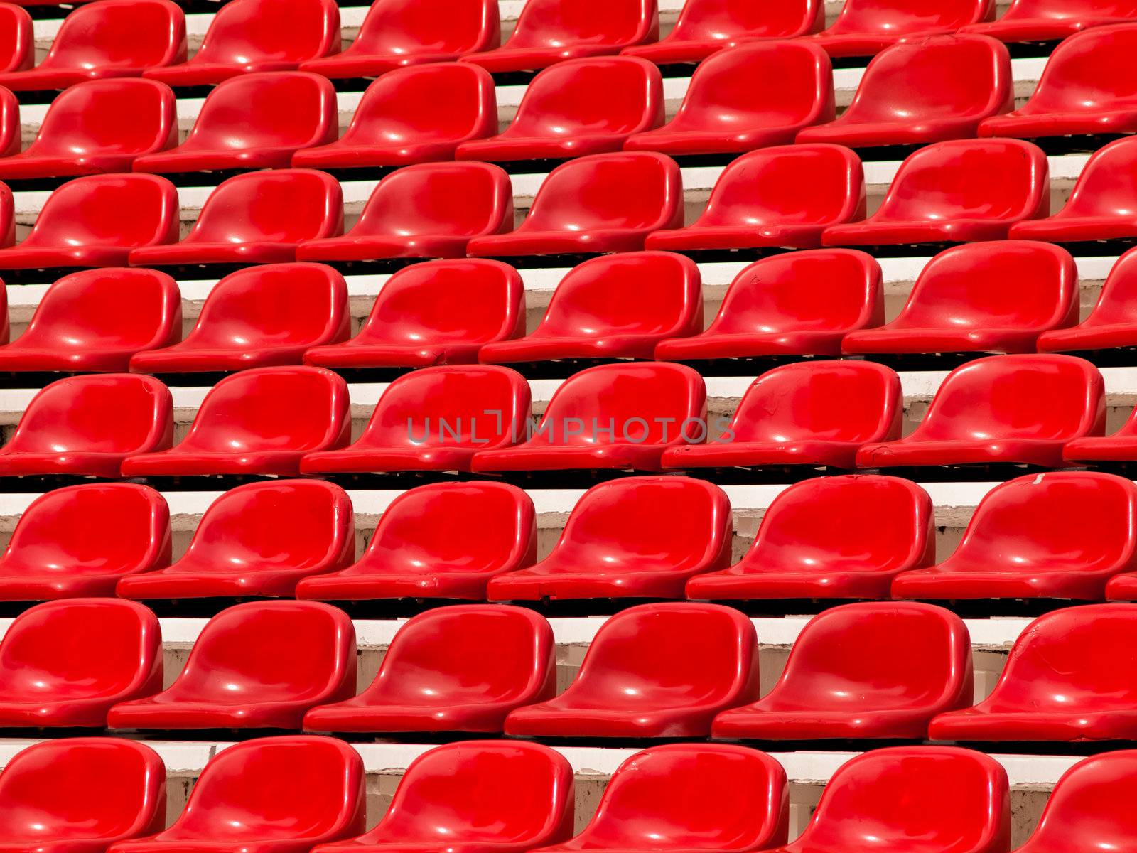 regular red seats in a stadium by jakgree