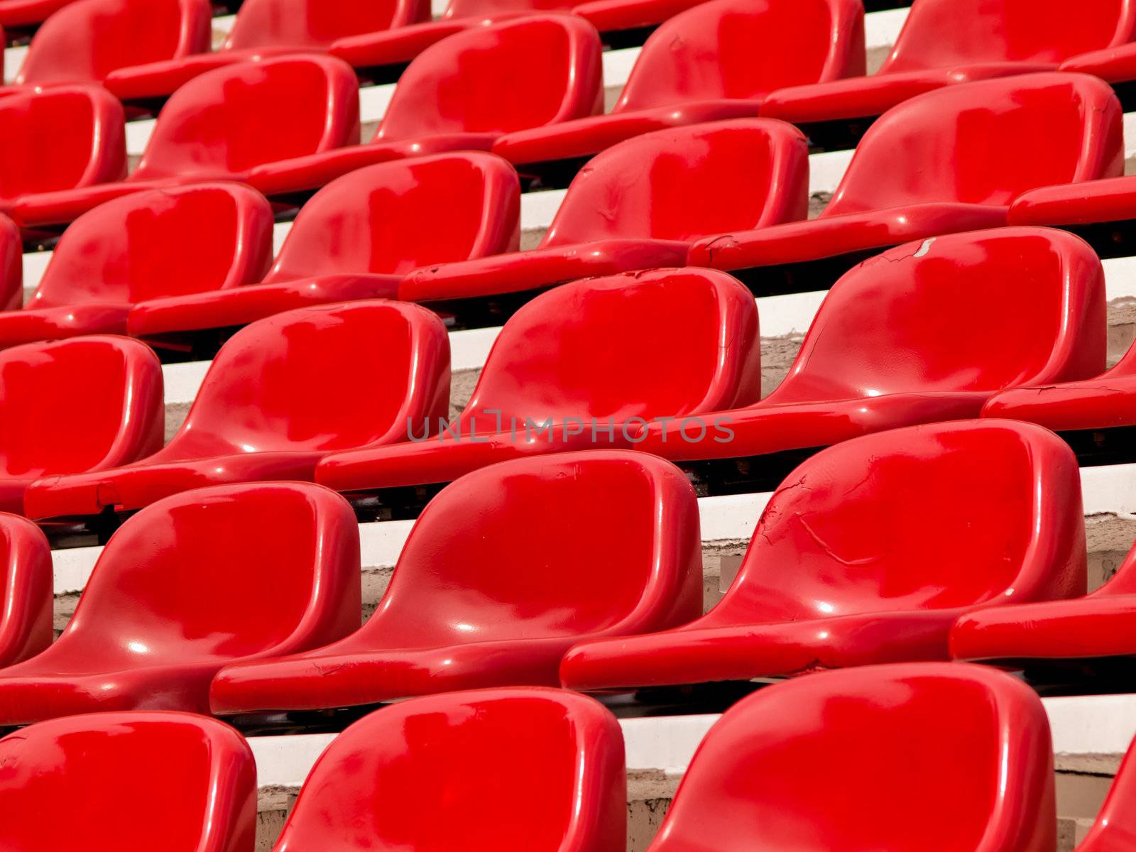 regular red seats in a stadium by jakgree