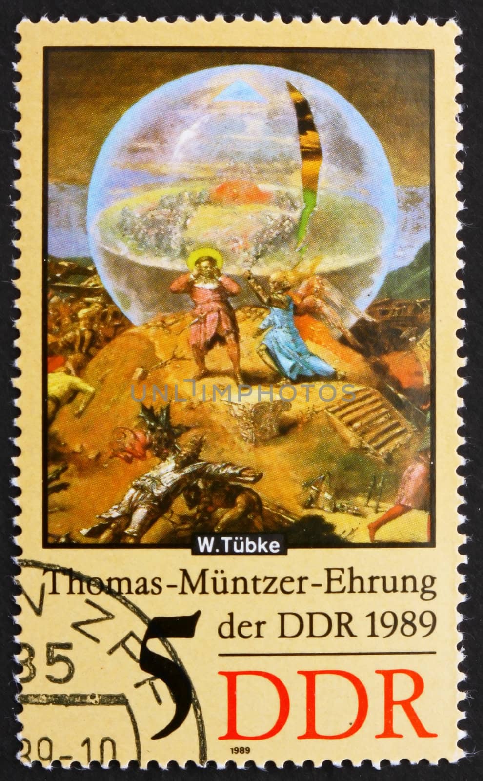 GDR - CIRCA 1989: a stamp printed in GDR shows Globe, Detail of the Painting Early Bourgeois Revolution in Germany in 1525 by Werner Tubke, circa 1989