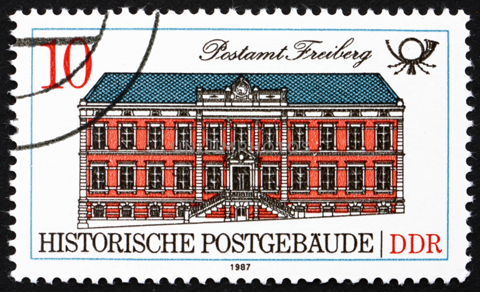 GDR - CIRCA 1988: a stamp printed in GDR shows Freiberg, Historic Post Office 1889, circa 1988