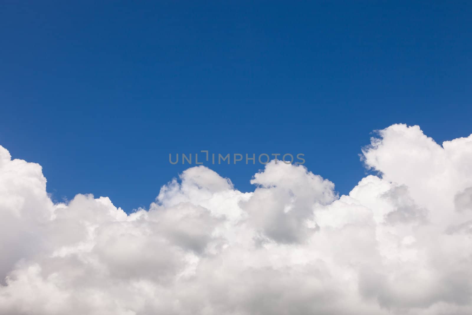 Beautiful Blue Sky with White Fluffy Cumulus Clouds Background with Copy Space