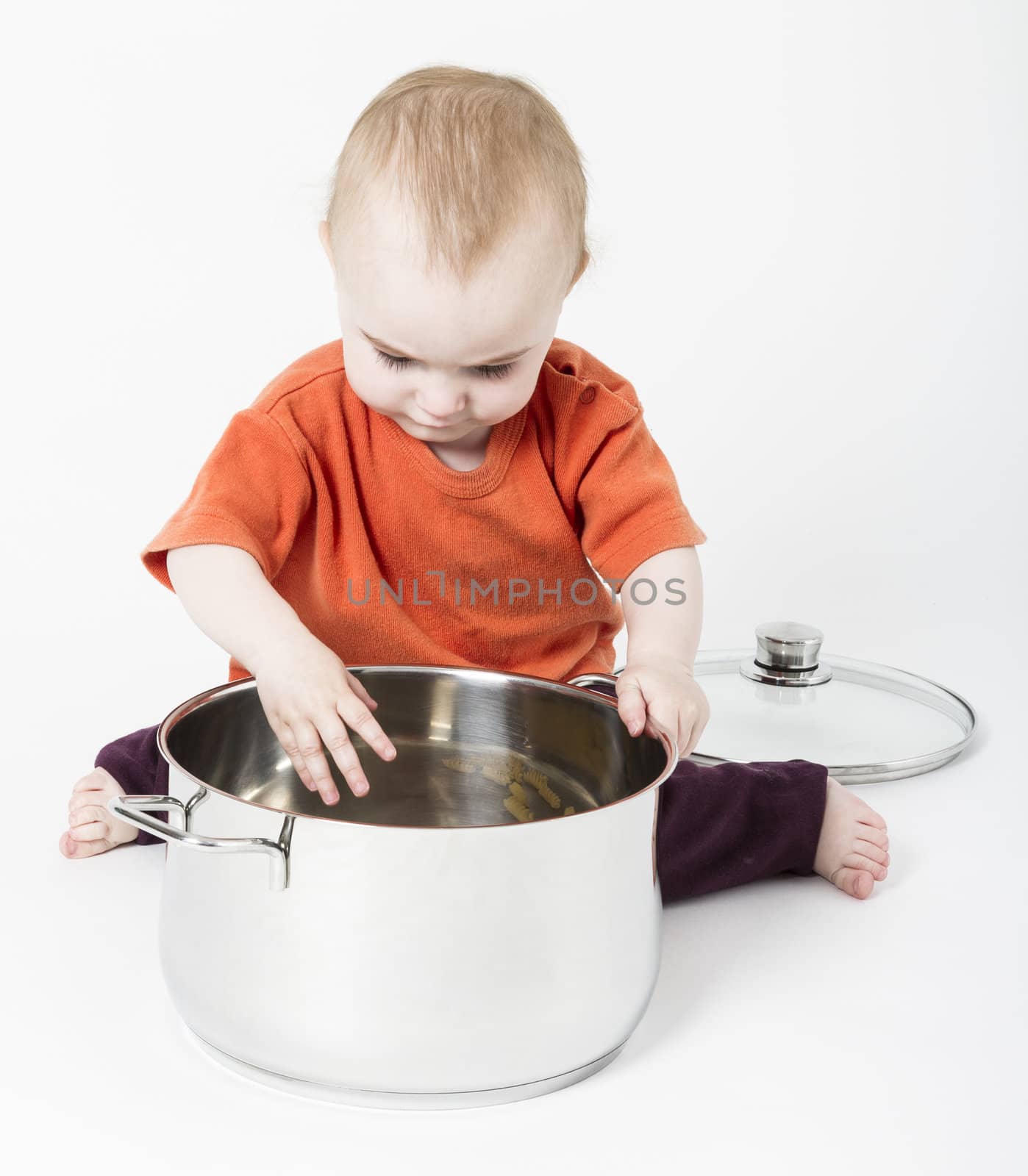 baby with big cooking pot on neutral background