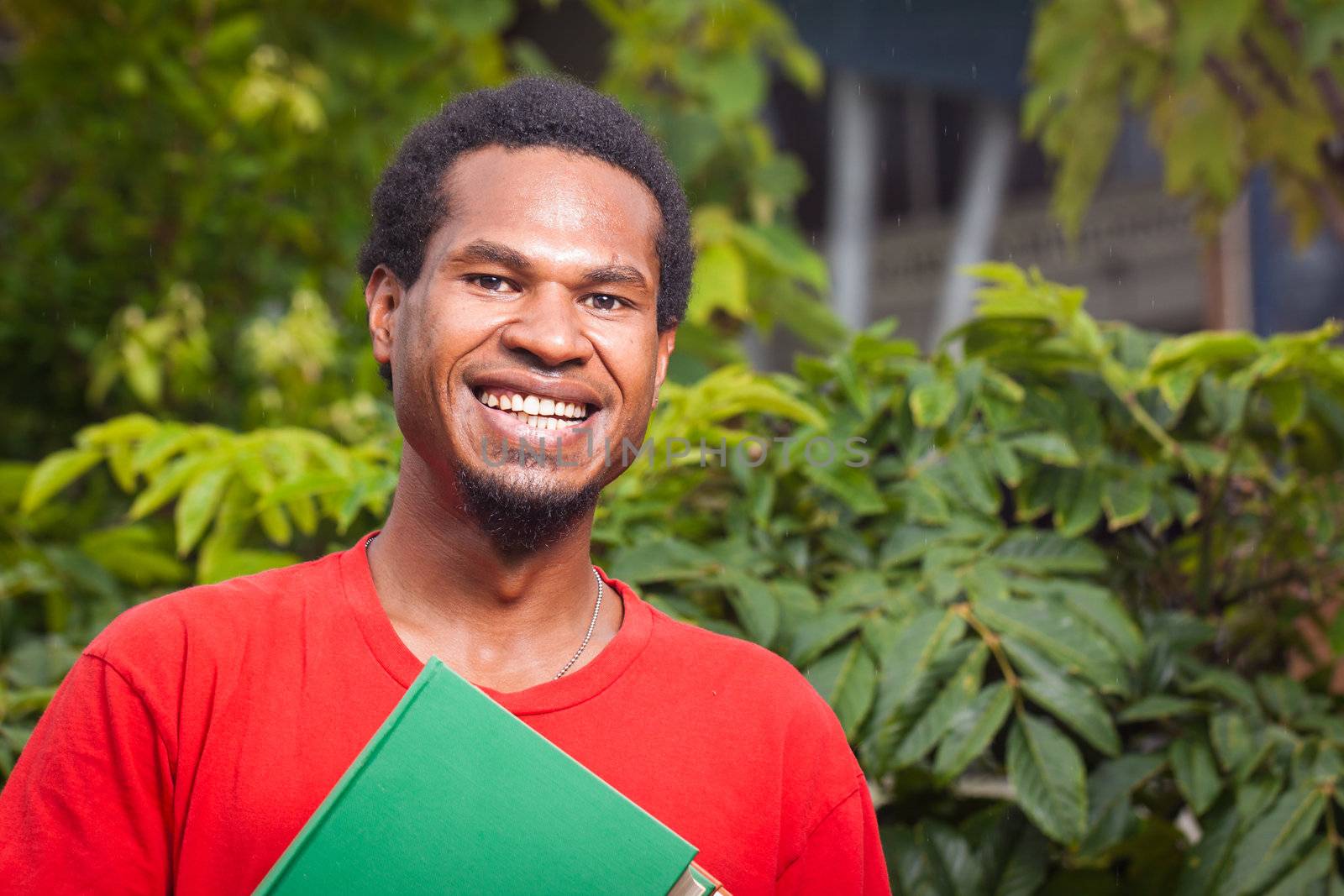 A happy dark skinned malel student