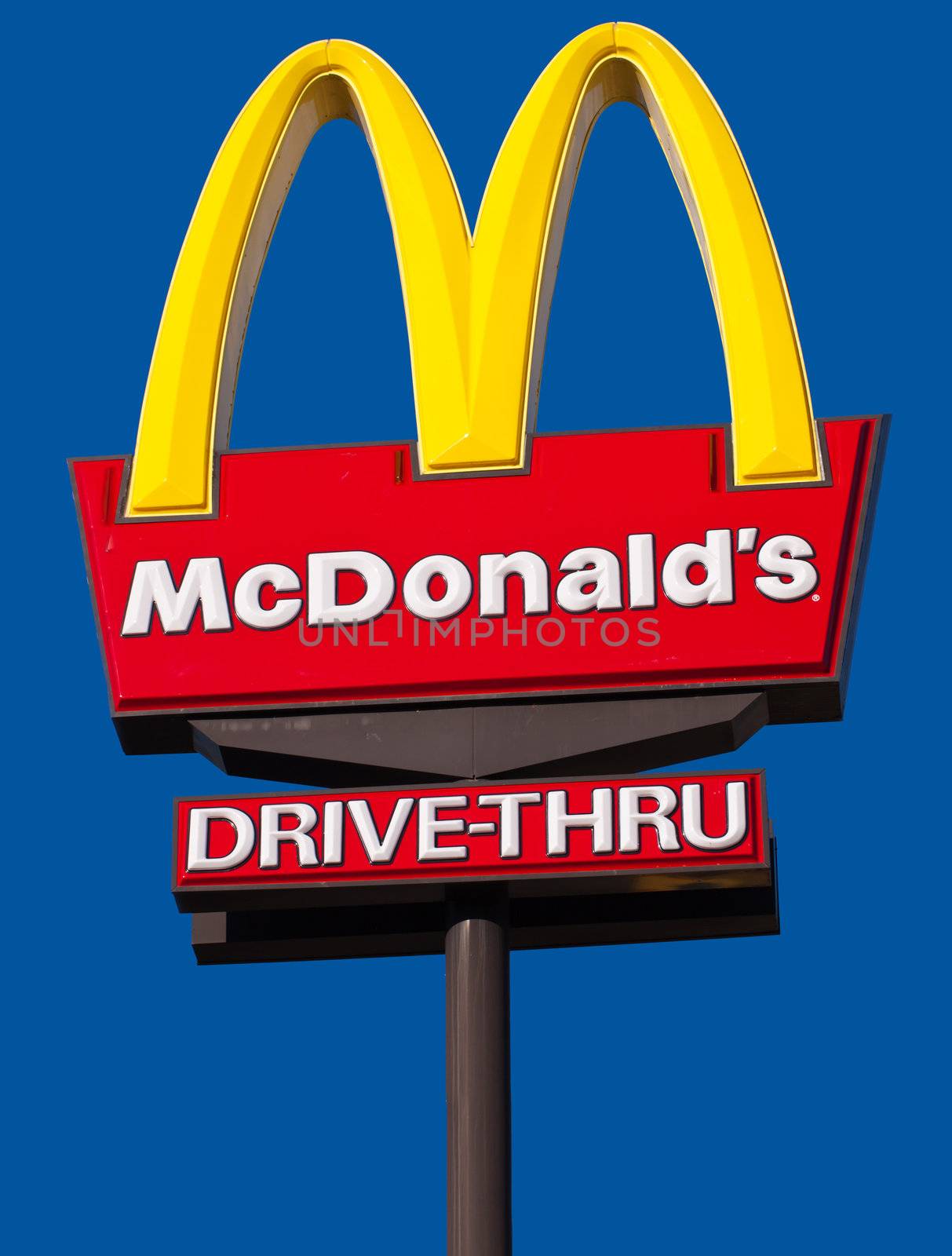 CAIRNS, AUSTRALIA - DECEMBER 2: McDonald's  logo and drive-thru sign against a blue sky background on Dec. 3, 2010 in Cairns, Australia. by Jaykayl