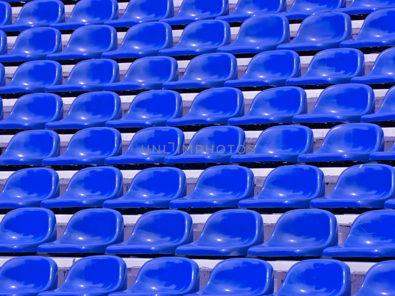 regular Blue seats in a stadium by jakgree