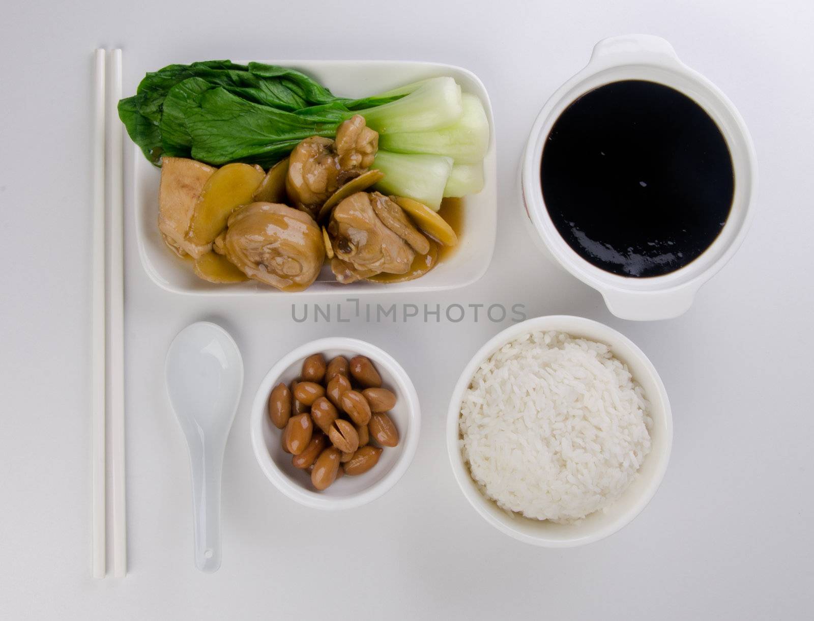 Chicken with rice and vegetables in background by heinteh