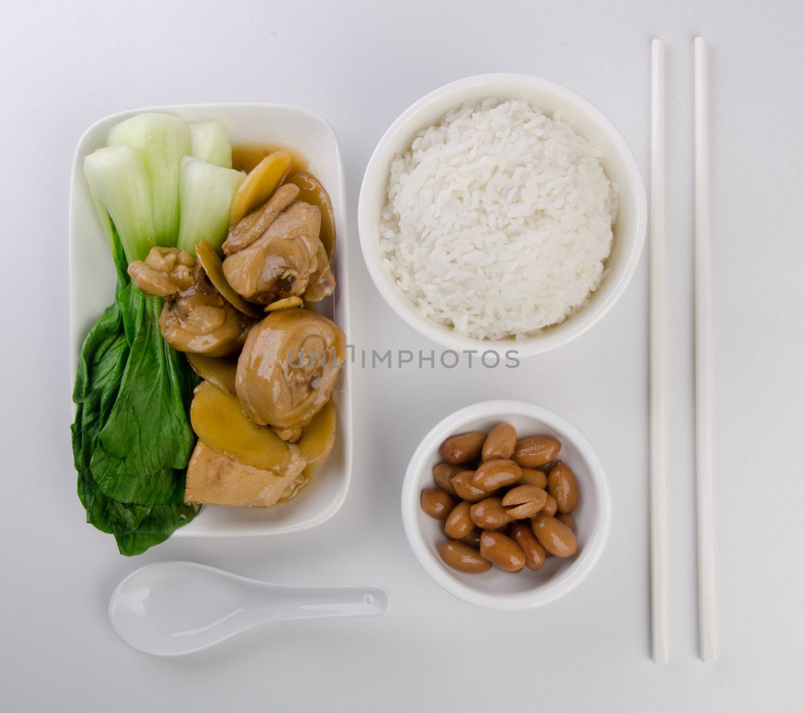 Chicken with rice and vegetables in background