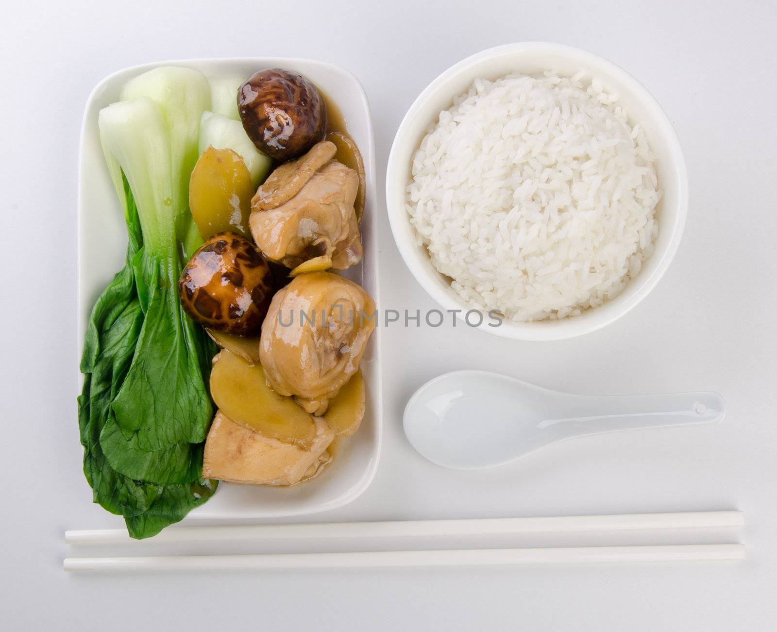 Chicken with rice and vegetables in background by heinteh
