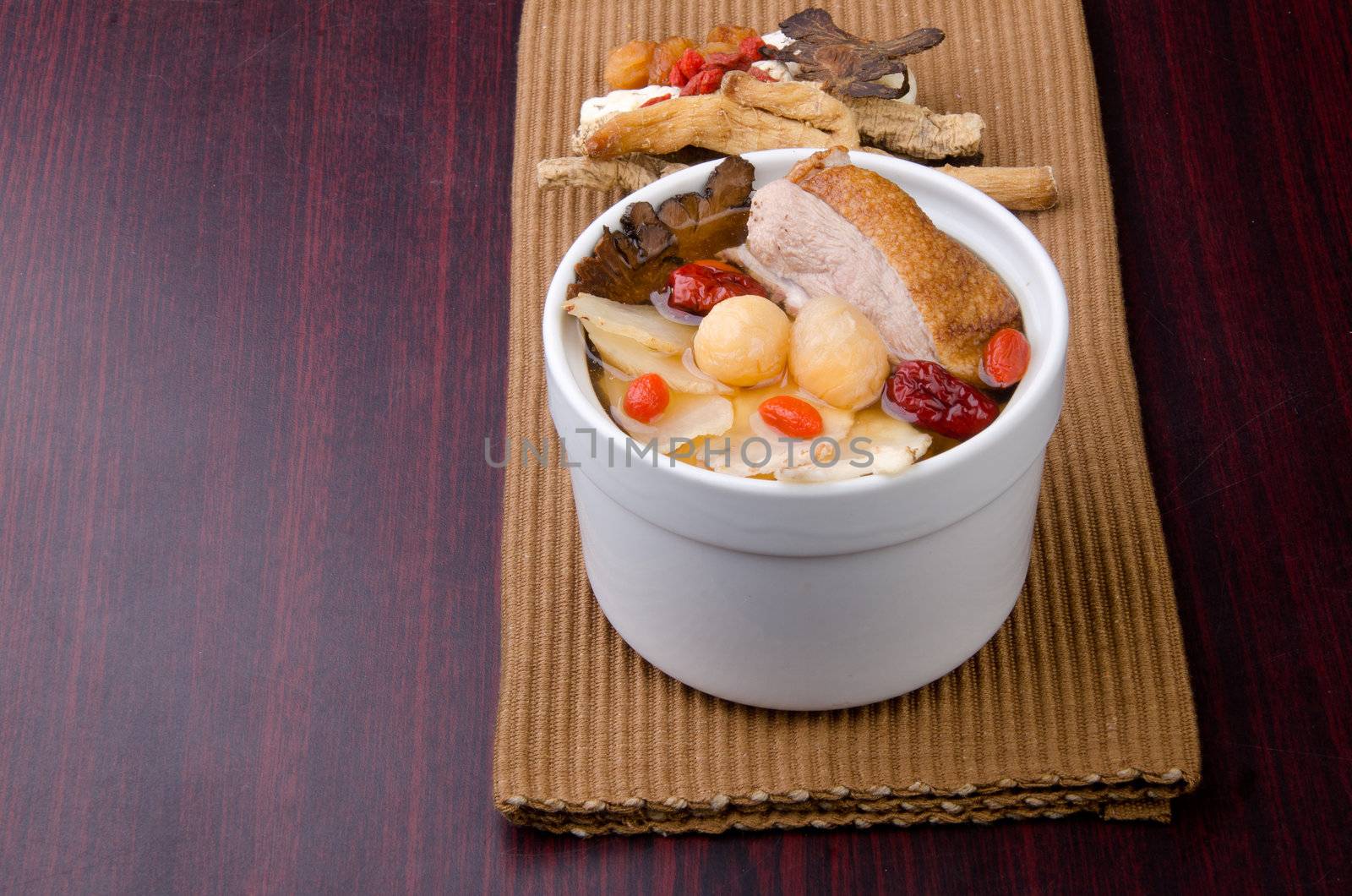 Chicken and herb soup in pot, Chinese food style.